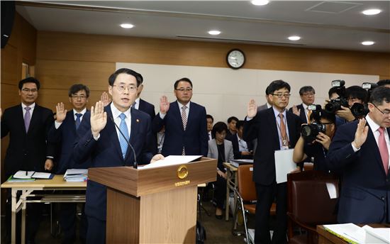 김재수 농림축산식품부 장관(앞줄 사진 왼쪽)은 26일 정부세종청사에서 열린 국정감사에서 선서를 하고 있다.