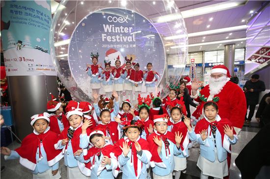 지난해 열린 '코엑스 윈터페스티벌'에서 어린이 합창단들이 외국인산타와 함께 기념촬영을 하고 있다.