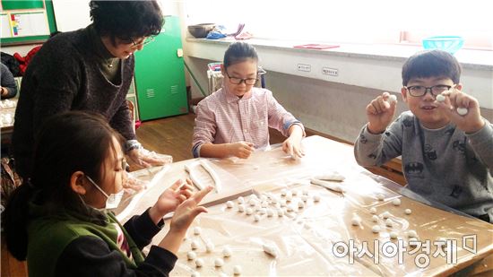광주 봉산초등학교 학생들이 지난 20일 이웃과 나눌 동지죽 새알을 빚고 있다.