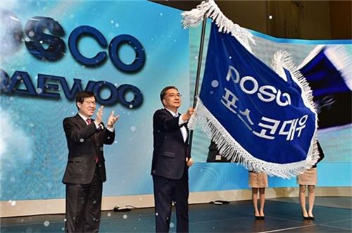 김영상 포스코대우 사장이 2016년 3월 신사명 선포식에서 사기(社旗)를 흔들고 있다.