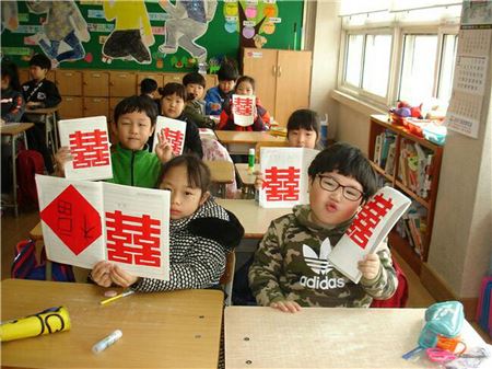 다문화 이해교육 강사를 통해 배운 어린이들이 중국 '쌍희' 글자를 만들어 보이고 있다. 