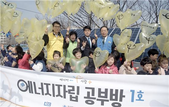 김영호 KCC 부사장(파란조끼)과 강남훈 한국에너지공단 이사장(노란조끼)가 '에너지자립 공부방 제1호' 만들기 프로젝트에 참석해 아이들과 풍선을 띄우며 기념촬영을 하고 있다.