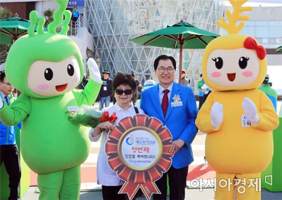서울에서 온 이인숙(64세)씨가 완도국제해조류박람회 내국인 첫 관람객으로 입장해 신우철 조직위원장과 기념사진을 찍고 있다.