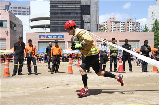 지난해 열린 서울시 최강 소방관 선발대회에서 한 소방관이 소방호스를 끌며 달리고 있다. 사진제공=서울시