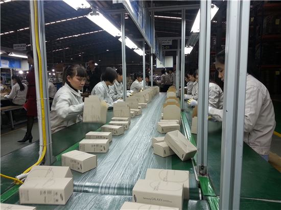 삼성전자의 베트남 현지 협력업체인 비엣 훙 플라스틱 직원들이 갤럭시 휴대폰 상자를 조립하고 있다. 