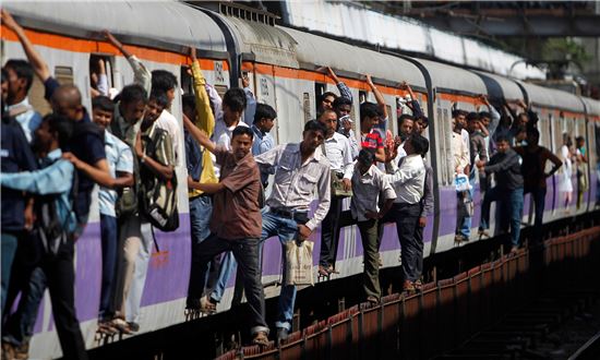 인도 최대도시 뭄바이는 노후한 열차에 매달려 목숨건 출근에 나선 승객들로 인한 크고 작은 사고가 끊이질 않는다. 인도 철도경찰 발표에 따르면 매일 650만 명을 시내 중심까지 나르는 탓에 혼잡시간엔 정원 200명 열차에 500명이 탑승하며, 이에 따른 사망자 수가 연간 4000여 명, 하루 평균 12명이 목숨을 잃는 '죽음의 출근열차'가 아닐 수 없다. 사진은 출근 길 뭄바이 열차 광경 