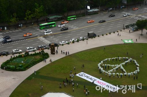 참여연대 회원들이 21일 서울시청 앞 광장에 모여 '피스몹(PeaceMob)' 행사를 진행하며 을지프리덤가디언 한미연합훈련 중단을 촉구하고 있다. (사진=문호남 기자)