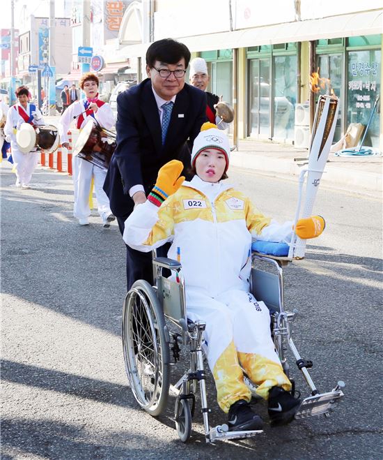 두번째 주자 염혜진씨와 김성 장흥군수가 함께 성화봉송을 이동시키고 있다.