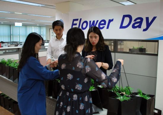 삼천리 직원들이 21일 '플라워데이' 행사를 열고 동료들에게 꽃 화분을 선물하고 있다.