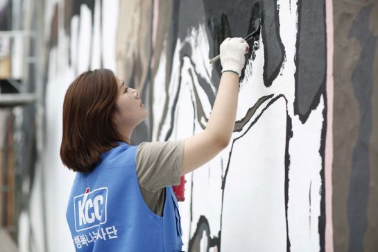 'KCC 행복나눔' 동호회 직원이 친환경 '숲으로' 페인트 제품으로 벽화 그리기에 참여하고 있다.