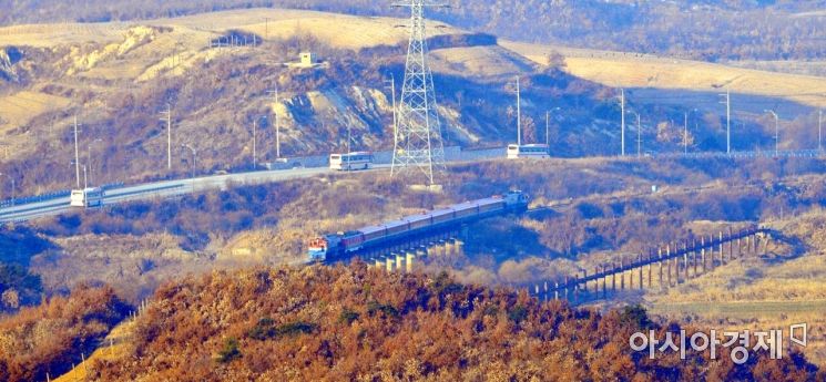 지난해 12월 26일 오전 북측 판문역에서 열리는 남북 철도·도로 연결 및 현대화 사업 착공식 참석자 등을 태운 열차가 도라산역 CIQ를 지나 판문역으로 향하고 있다. <사진=공동취재단>