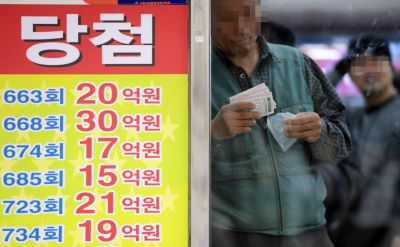 팍팍한 삶에서 탈출구를 찾는 시민들의 발걸음이 머무는 곳이 있다. 바로 로또 명당이다. 2019년 1월 21일 서울 노원구의 한 로또명당에서 시민들이 희망이 담긴 로또를 구입하고 있다.