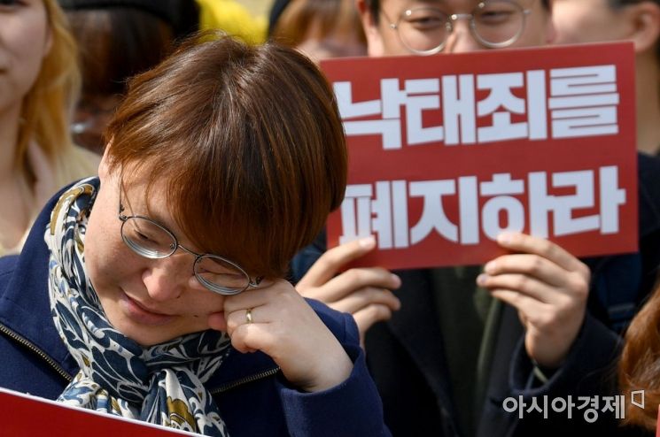 낙태죄에 대한 위헌판결이 난 11일 서울 헌법재판소 앞에서 낙태죄 위헌을 촉구했던 여성단체 관계자들이 판결 소식을 들은 뒤 눈무을 닦고 있다./강진형 기자aymsdream@