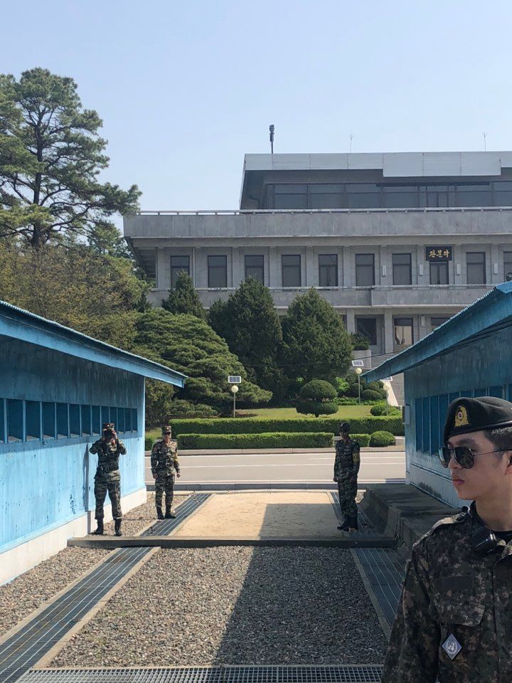 1일 오전 판문점 공동경비구역(JSA) 남측 지역 견학이 재개된 가운데, 북한 군인 3명이 북측 지역에서 남측 관광객을 촬영하고 있다. [사진공동취재단]