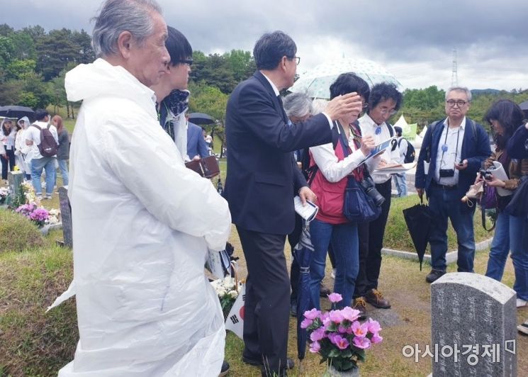 야스오 요시스케(72) 전 교도통신 기자(왼쪽에서 첫번째)가 18일 국립 5.18 묘역에서 희생자 묘비를 바라보고 있다. (사진=전진영 기자)