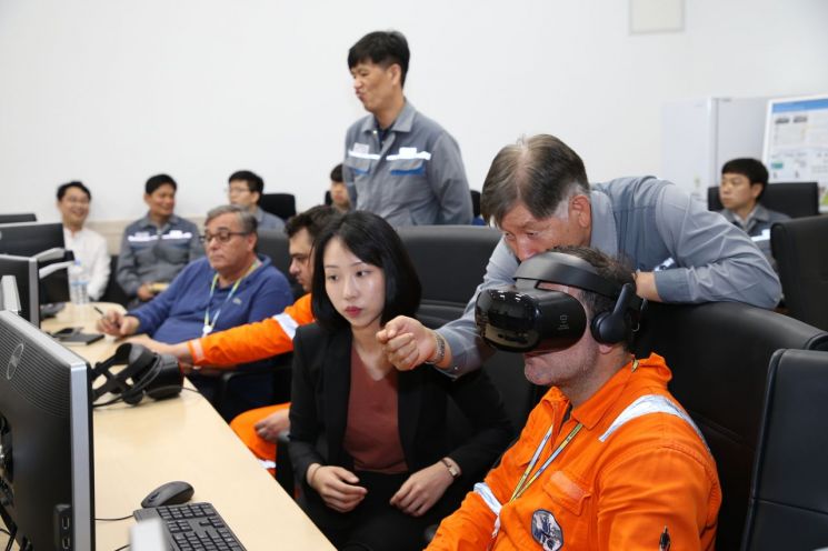 지난 7일 옥포조선소에서 대우조선해양 관계자가 LNG운반선 선원에게 VR 선원교육시스템을 설명하고 있다.