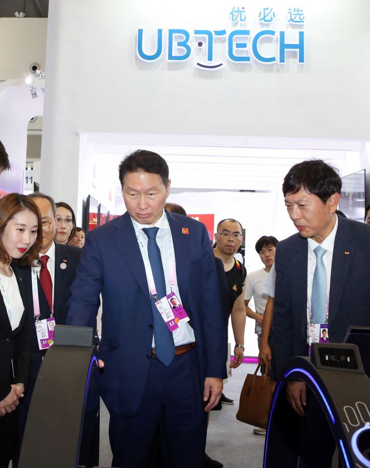 최태원 SK회장(가운데)이 26일 중국 충칭시 국제엑스포센터에서 열린 '2019 스마트 차이나 엑스포'에서 글로벌 IT 기업들의 전시관을 둘러보고 있다.