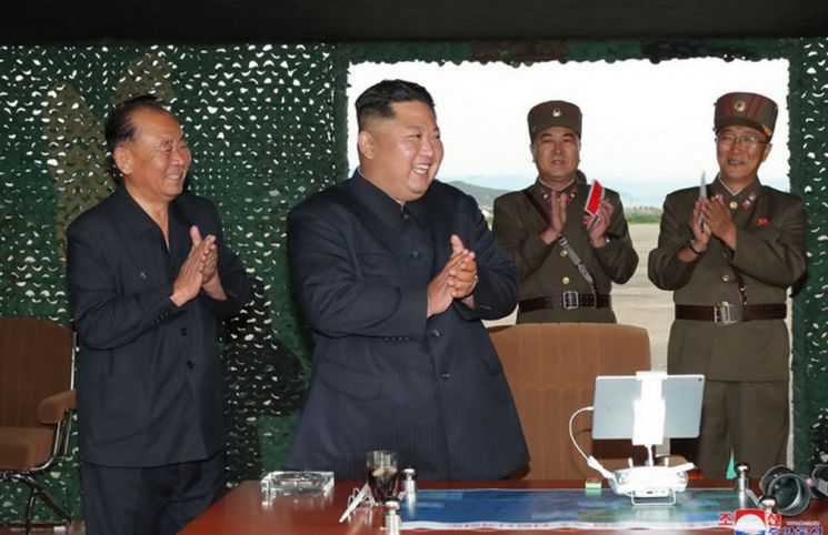 북한이 지난 24일 '새로 연구 개발한 초대형 방사포'를 김정은 국무위원장의 지도 하에 성공적으로 시험발사했다고 조선중앙통신이 25일 보도했다. 사진은 중앙통신 홈페이지에 게재된 김 위원장의 발사 참관 모습.
