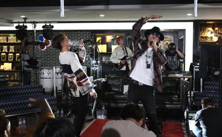 CJ ENM 오쇼핑부문의 모바일 쇼핑방송 '쇼크라이브'에 출연해 노래를 선보이고 있는 타이거JK(오른쪽)와 비지.