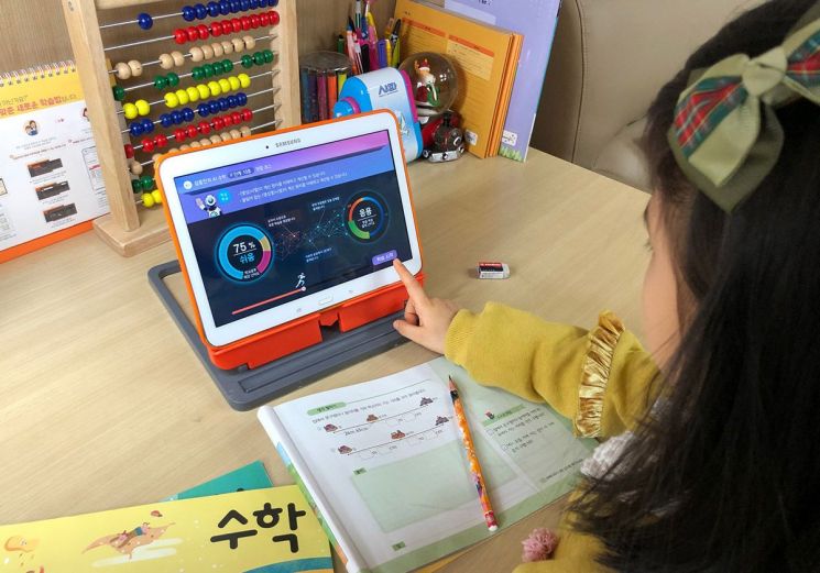 웅진씽크빅 'AI 수학' 스마트 학습 서비스를 이용하는 어린이가 학습 목표와 난이도를 확인하고 있다.