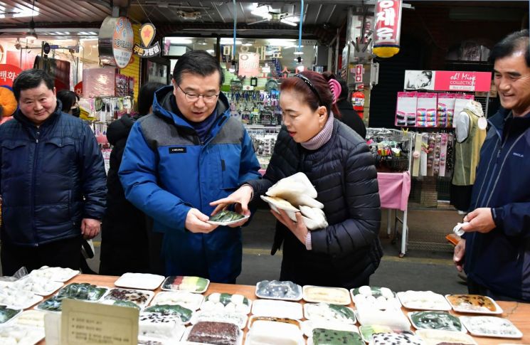 류경기 중랑구청장이 동원전통종합시장에서 물건을 사고 있다.
