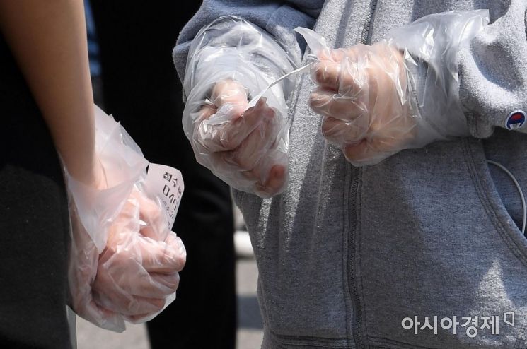 [포토] 비닐장갑 낀 손에 들린 번호표