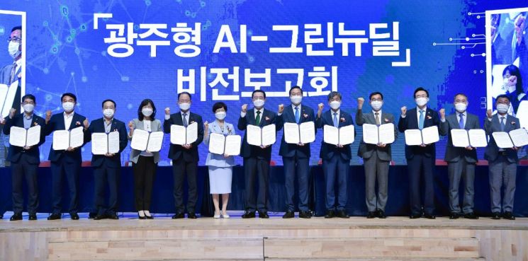 이용섭 광주광역시장이 21일 오후 서구 김대중컨벤션센터 다목적홀에서 열린 '광주형 AI-그린뉴딜' 비전 보고회에서 광주시의회, 전라남도, 한전 등 12개 기관·단체와 '광주형 AI-그린뉴딜 실현 업무협약'을 체결한 뒤 기념촬영을 하고 있다. 사진=광주광역시 제공