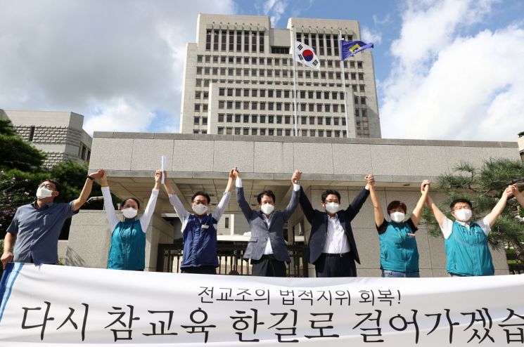 권정오 전국교직원노동조합 위원장(가운데)과 조합원 등이 3일 오후 서초동 대법원 앞에서 선고 뒤 열린 기자회견에서 기쁨을 표현하고 있다.  
    대법원 전원합의체는 이날 전교조가 고용노동부를 상대로 낸 법외노조 통보 처분 취소 소송 상고심에서 원고 패소로 판결한 원심을 깨고 원고 승소 취지로 사건을 서울고법으로 돌려보냈다. [이미지출처=연합뉴스]