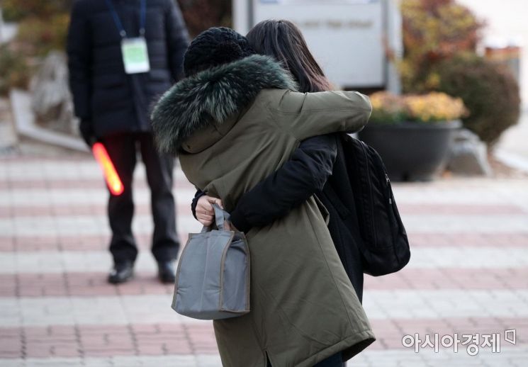 2021학년도 대학수학능력시험이 시행된 3일 서울 영등포구 여의도여자고등학교에서 한 수험생이 어머니의 응원을 받으며 고사장으로 향하고 있다./김현민 기자 kimhyun81@