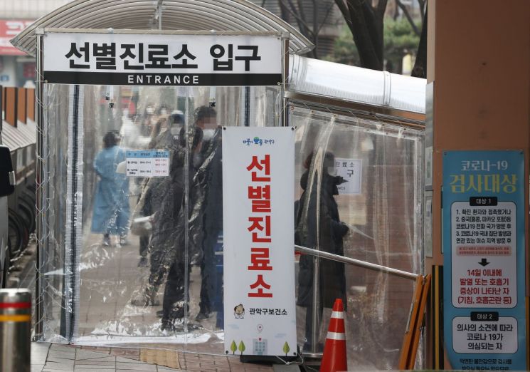 22일 오전 서울 관악구보건소 선별진료소에서 시민들이 신종 코로나바이러스감염증(코로나19) 검사를 받기 위해 길게 줄을 서 있다.<이미지:연합뉴스>