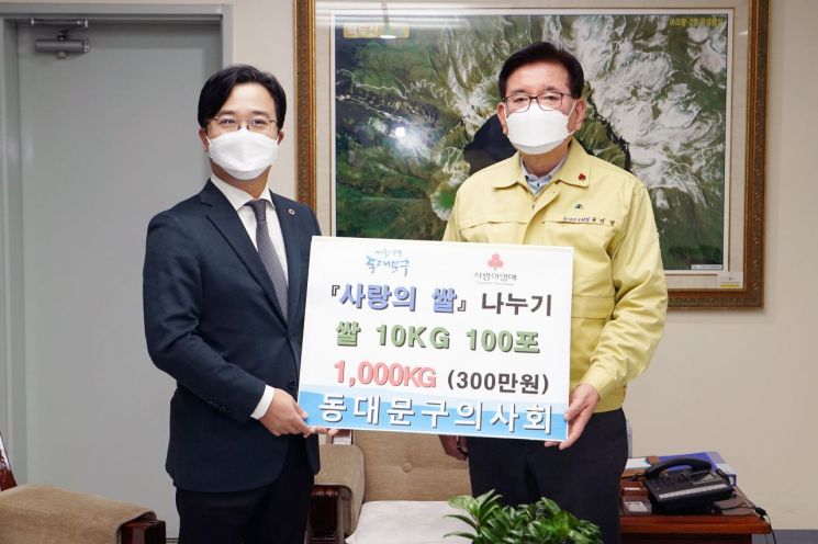 이태연 동대문구의사회 회장이 유덕열 동대문구청장에게 쌀을 전달하고 있다.