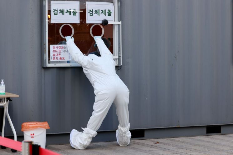 코로나19 신규 확진자가 1200명대를 기록한 25일 오후 서울광장에 마련된 임시선별진료소에서 의료진이 몸을 풀고 있다. [이미지출처=연합뉴스]