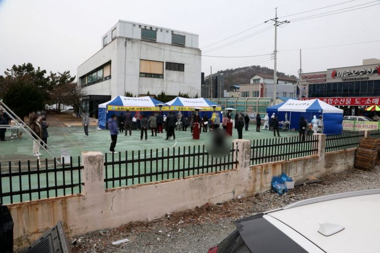 27일 경북 포항시 남구 구룡포읍 구룡포읍민도서관 옆에 마련된 '긴급 선별진료소'에서 구룡포 주민들이 코로나19 검사를 받기위해 장사진을 치고 있다. [이미지출처=연합뉴스]