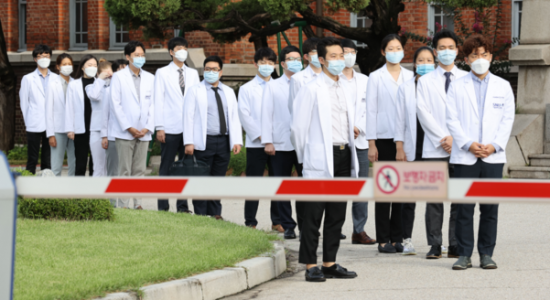 지난해 8월23일 오전 서울 종로구 서울대병원 대학의원 본관 앞에서 정부의 의료정책에 반대하는 전공의들이 의사 가운을 탈의하기 위해 대기하고 있다./연합뉴스