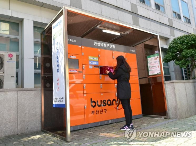 무인 안심 택배보관함에서 한 시민이 물품을 수령하고 있다. [이미지출처=연합뉴스]