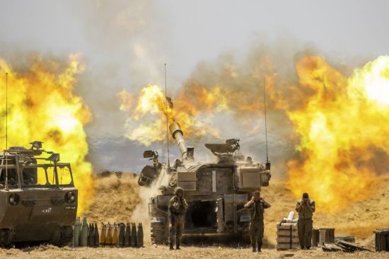 이스라엘과 팔레스타인 자치 지역인 가자지구 경계에서 12일(현지시간) 이스라엘군 야포가 포탄을 쏘고 있다. 이스라엘군은 가자지구 무장 정파 하마스와 사흘째 화력전을 벌이면서 사상자가 급증하고 있다. [이미지출처=AP연합뉴스]