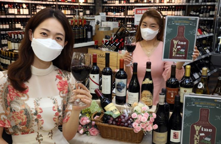 지난 12일 오전 이마트 용산점 와인 매장에서 모델들이 '상반기 와인장터' 행사를 소개하고 있다.