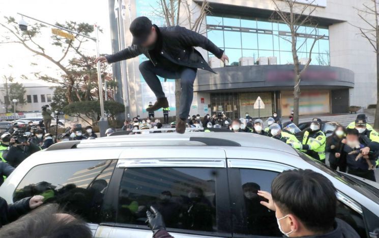 형기를 마치고 출소한 아동 성범죄자 조두순이 탑승한 관용차량이 지난해 12월12일 오전 경기도 안산시 법무부안산준법지원센터에서 나오던 중 일부 시민과 유튜버 등에 가로막혀 있다. / 사진=연합뉴스