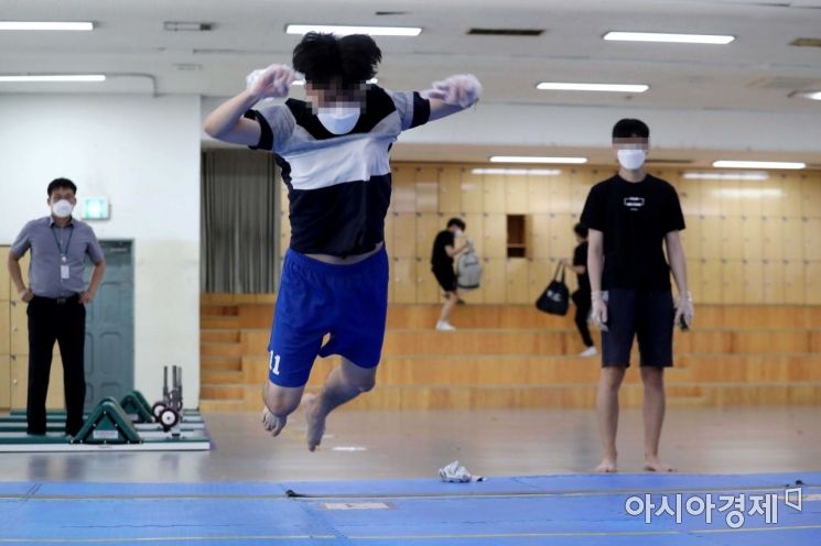 시험 응시생들이 제자리 멀리뛰기를 하고 있다. /문호남 기자 munonam@