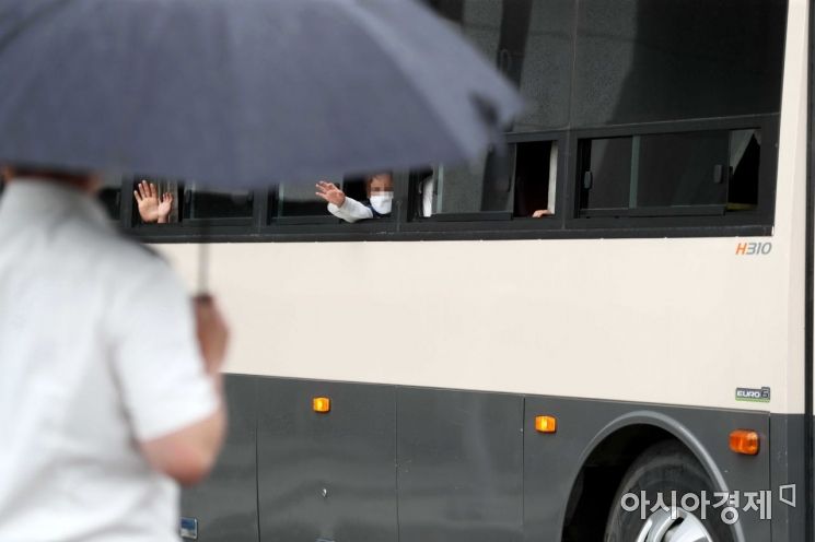 과거 한국을 도운 아프간인을 태운 버스가 27일 경기 김포 마리나베이 호텔에서 충북 진천의 국가공무원 인재개발원으로 이동하고 있다. 어린이들이 시설 방역 관계자와 경찰, 취재진을 향해 손을 흔들고 있다. /문호남 기자 munonam@
