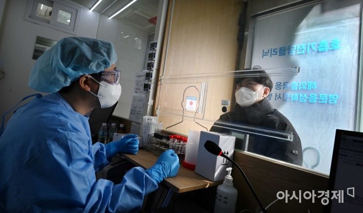 지난달 3일 서울 강남구 역삼동 하나이비인후과에 마련된 호흡기전담클리닉에서 의료진이 호흡기질환 환자와 칸막이를 사이에 두고 진료를 하고 있다. /사진공동취재단