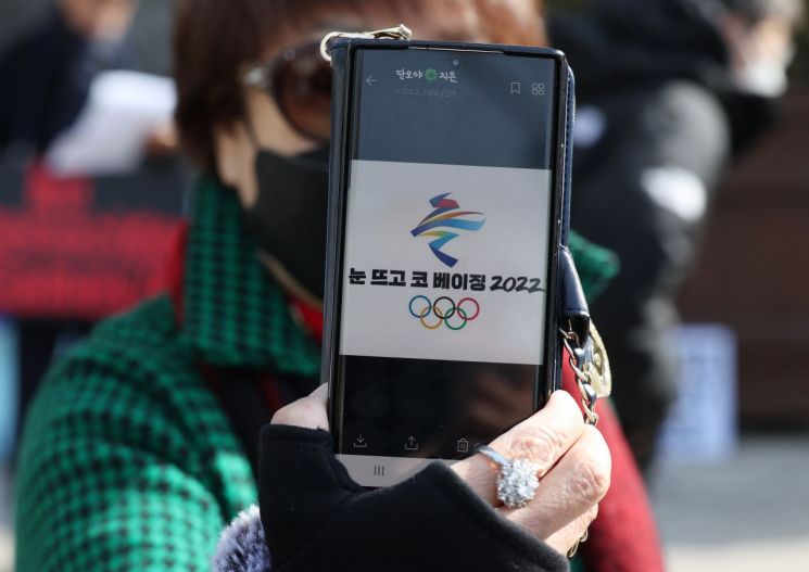 9일 중국대사관 인근에서 나라지킴이고교연합, 자유수호포럼 주최로 중국의 탈북자 강제북송 반대와 인권문제 해결 촉구 등을 주장하는 반중 집회가 열렸다. 한 참가자가 2022 베이징 동계 올림픽을 비판하는 '눈 뜨고 코 베이징' 문구가 담긴 이미지를 보여주고 있다./사진=연합뉴스