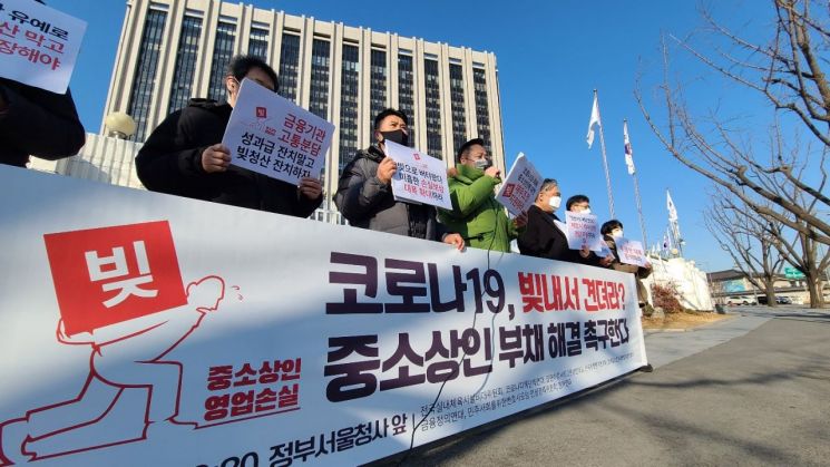 코로나피해단체연대 등 중소상인 단체 회원들이 18일 정부 서울청사 앞에서 코로나19 피해로 인한 소상공인 부채의 해결을 촉구하며 기자회견을 하고 있다. / 사진=연합뉴스