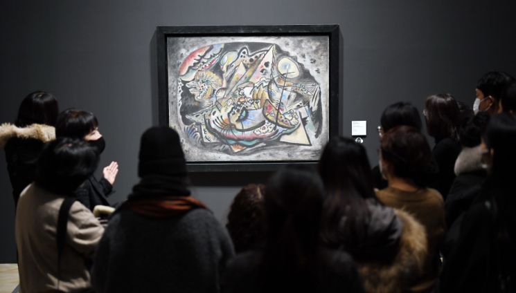 Visitors viewing the exhibition 'Kandinsky, Malevich & Russian Avant-Garde'.