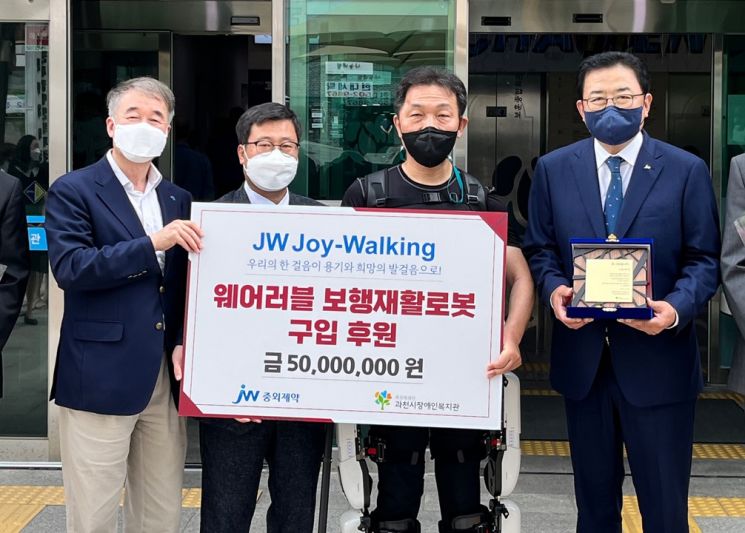 JW그룹이 'JW 조이워킹(JW Joy-Walking)' 캠페인을 통해 마련한 기부금 5000만원을 19일 경기도 과천시장애인복지관에 기부했다. 왼쪽부터 백경학 푸르메재단 상임이사, 이학준 과천시장애인복지관장, 웨어러블 로봇재활 참여자 이희성씨, 신영섭 JW중외제약 대표이사.