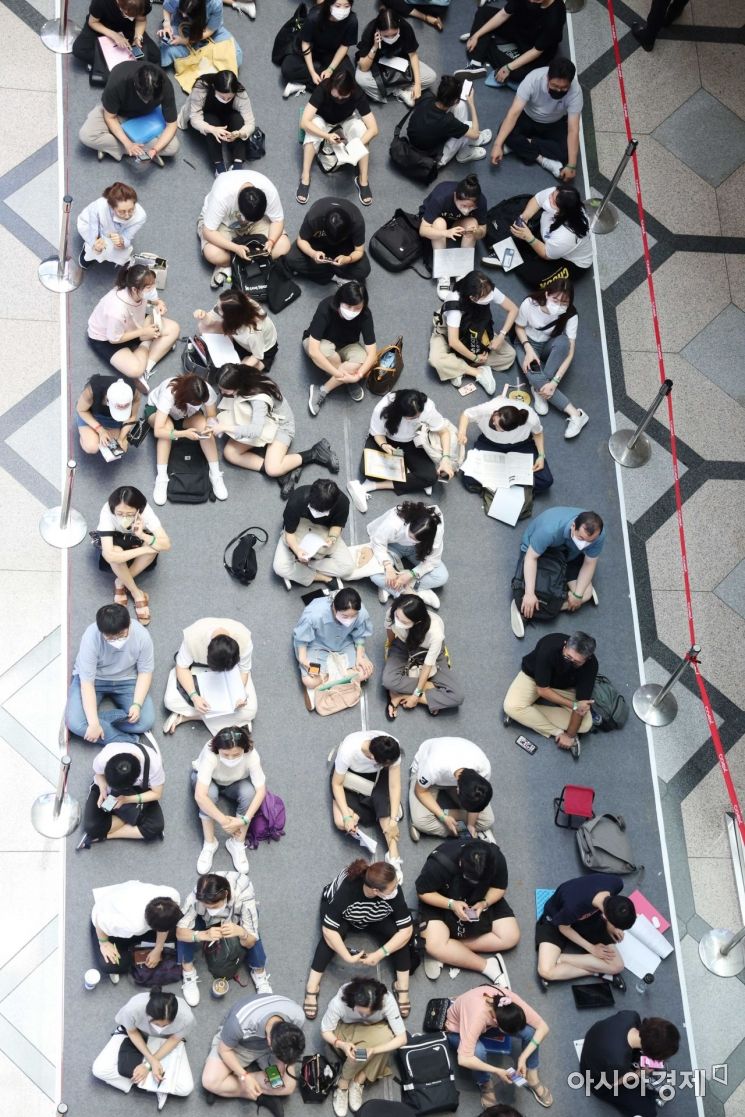 20일 서울 강남구 코엑스 A홀에서 한국대학교육협의회 주최로 열린 ‘2023학년도 수시 대학입학정보박람회’에서 학생과 학부모들이 바닥에 앉아 입장을 기다리고 있다. /문호남 기자 munonam@