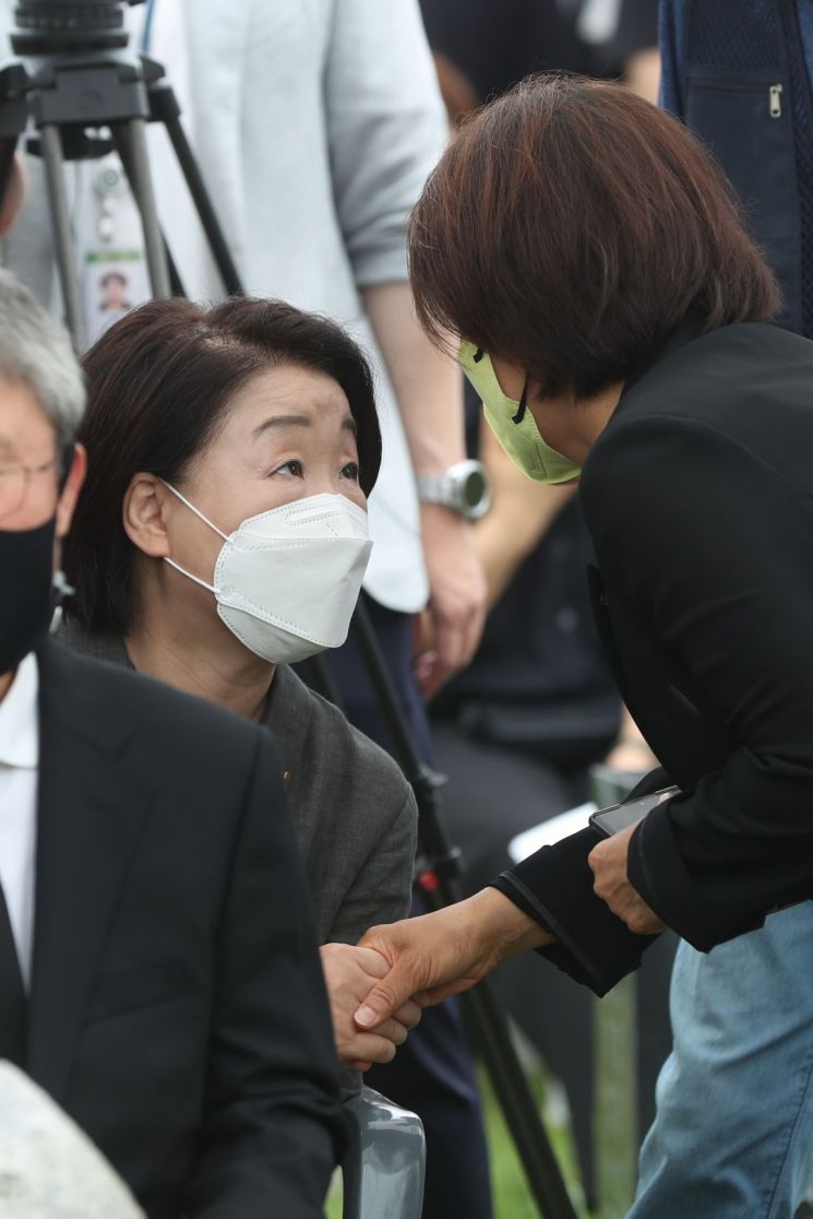 정의당 이은주 비대위원장(오른쪽)이 23일 경기도 남양주시 모란공원에서 열린 고(故) 노회찬 의원 4주기 추모제에서 정의당 심상정 의원과 인사하고 있다. [이미지출처=연합뉴스]