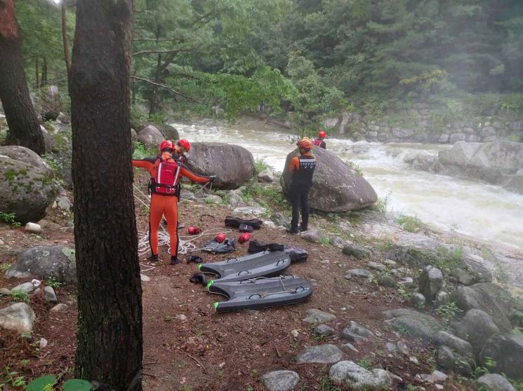 지난 11일 오후 1시16분께 강원 강릉시 연곡면 삼산리 솔봉 계곡 인근에서 60대가 급류에 휩쓸려 실종돼 소방대원들이 수색하고 있다. [이미지출처=연합뉴스]