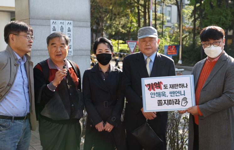 윤석열 대통령 부인 김건희 여사가 과거 유흥주점에서 일했다는 이른바 '쥴리 의혹'을 제기한 안해욱 전 대한초등학교태권도협회장(오른쪽 두번째) 등이 13일 오전 서울중앙지법에서 열리는 1심 1회 공판준비기일에 출석하기 전 카메라 앞에 서 있다. [이미지출처=연합뉴스]