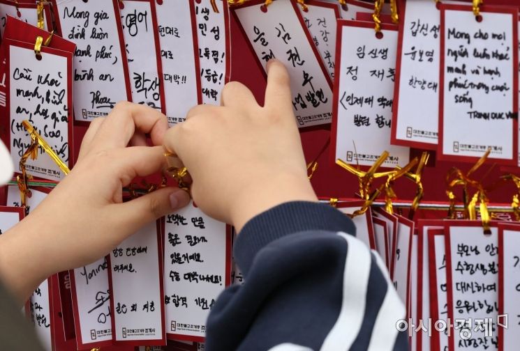2023학년도 대학수학능력시험을 앞둔 마지막 주말인 13일 서울 종로구 조계사를 찾은 한 학부모가 수능대박기원을 담은 메세지를 남기고 있다./윤동주 기자 doso7@